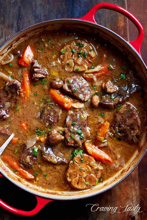 Braised beef cooked in a cast iron braising pan with mushrooms, leeks ...