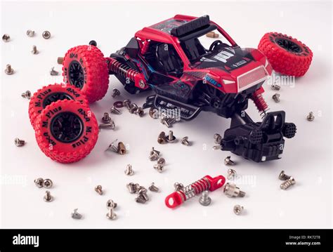 Disassembled car and scattered parts. Broken toy Stock Photo - Alamy