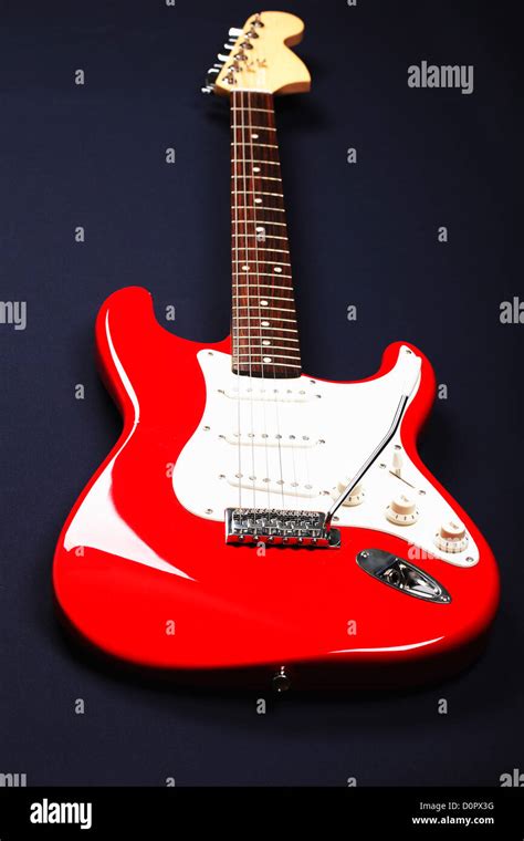 Red and white guitar over blue Stock Photo - Alamy