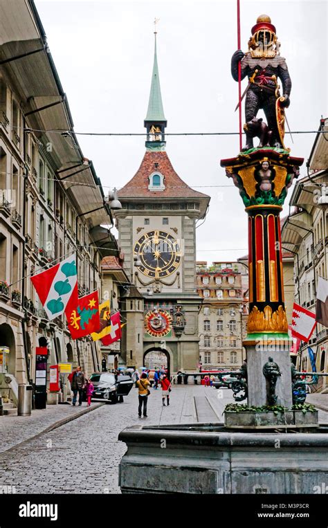 Fountain with sculpture and Clock Tower, Zytglogge in rainy day, Bern ...