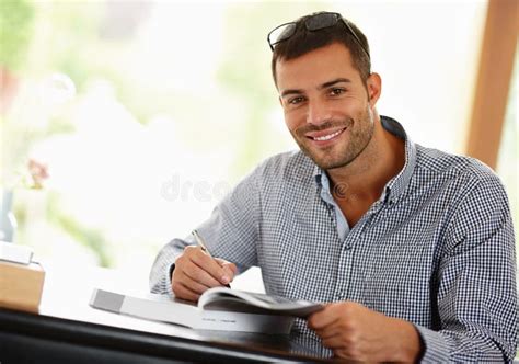 Hes the Boss of His Books. Portrait of a Smiling Young Man Studying ...