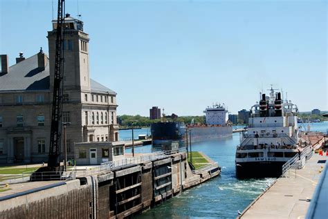 two large ships are docked in the water next to a building and another ...