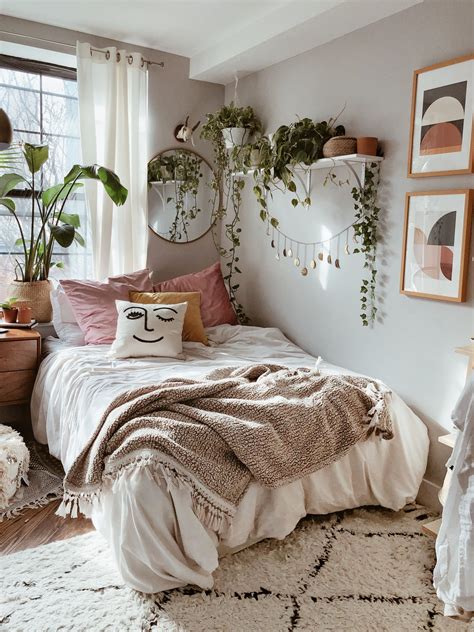 the bedroom is decorated with plants and pictures on the wall, along ...