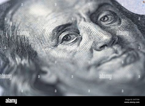 Close-up shot of a 100 dollar bill with the face of Benjamin Franklin ...