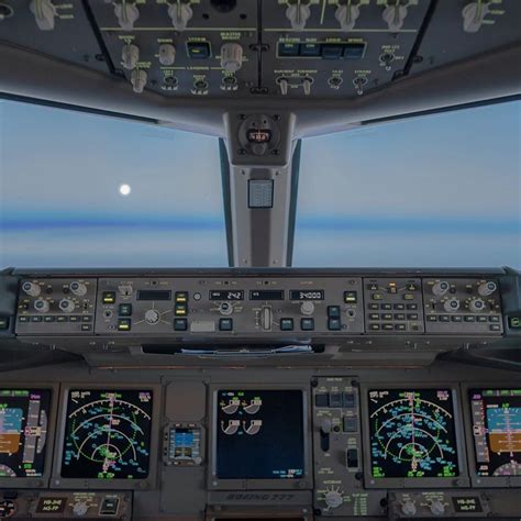 Boeing 777 cockpit. As we are cruising through the night the moon is ...