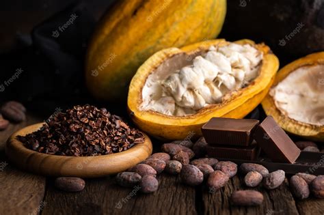 Premium Photo | Cocoa pods, beans and powder on wooden table, top view