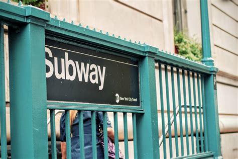 a subway sign at the entrance to new yorks underground transit system ...