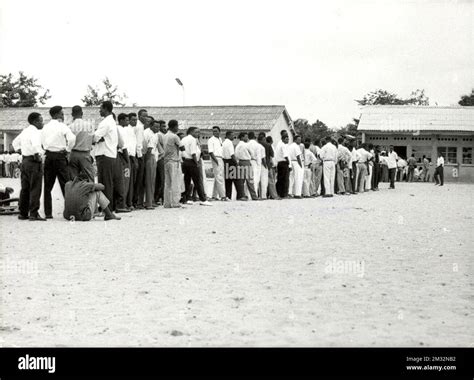 19600630 - LEOPOLDVILLE, CONGO: Men wait in line during election voting ...