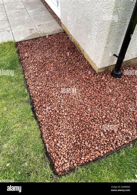 Red stone garden path at back of house Stock Photo - Alamy