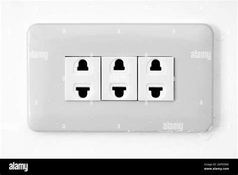 Wall socket in the philippines in white with three power plug sockets ...