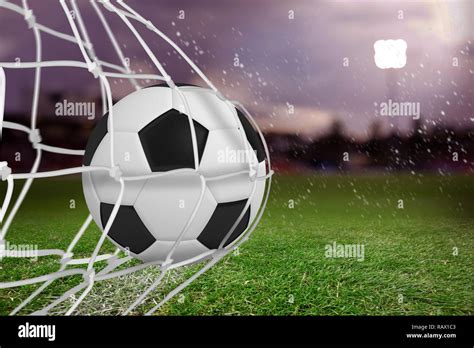 Composite image of soccer ball in goal net Stock Photo - Alamy