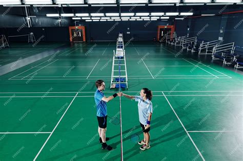 Premium Photo | Badminton players training in gymnasium