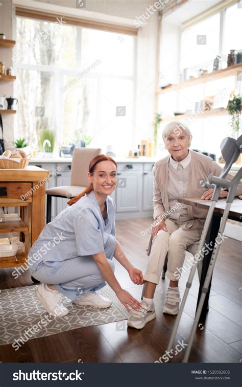 Caregiver Smiling Caregiver Wearing Uniform Smiling Stock Photo ...