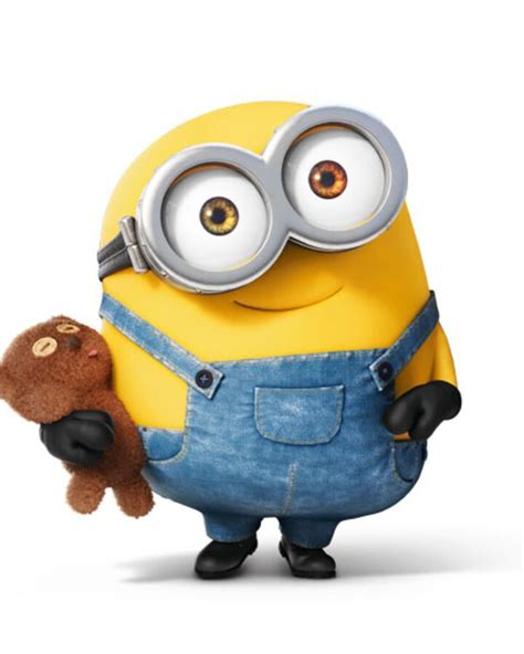 a minion holding a teddy bear in his right hand and looking at the camera