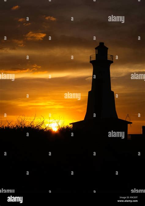 Lighthouse silhouette against a beautiful sunset Stock Photo - Alamy