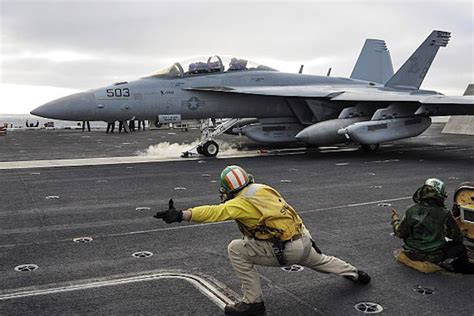 U.S. Navy aircraft carrier flight deck crews use computer simulation to ...