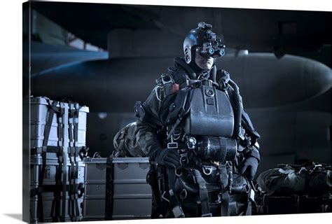 U.S. Navy Seal equipped with night vision prepares for HALO jump ...