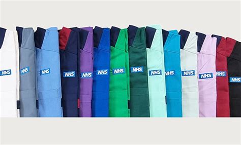 A photo of 14 differently coloured NHS uniforms