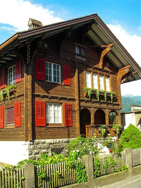 Classic Swiss Chalet and garden in spring in the Alps near the city ...