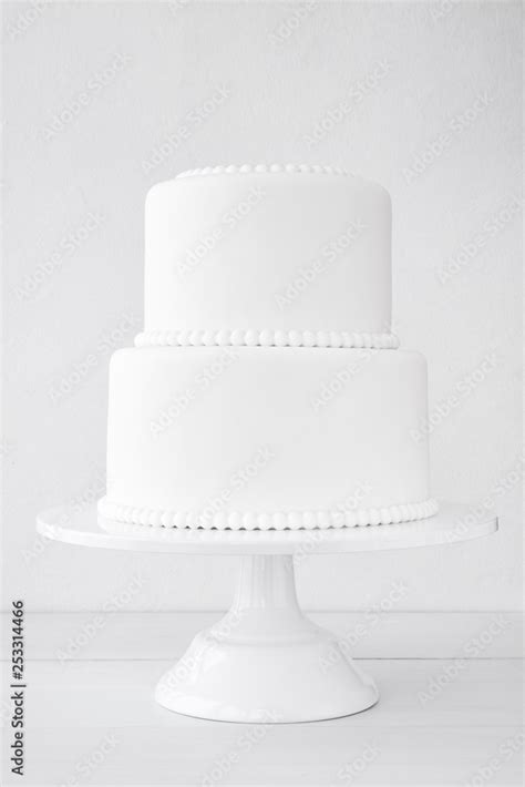 White wedding cake blank on a white background. Simple minimalism ...