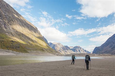 Rear View Of Two Men Hiking In Akshayak Pass, Auyuittuq National Park ...