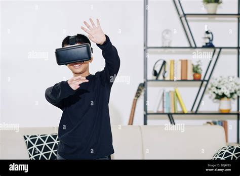 Boy playing game in VR glasses Stock Photo - Alamy