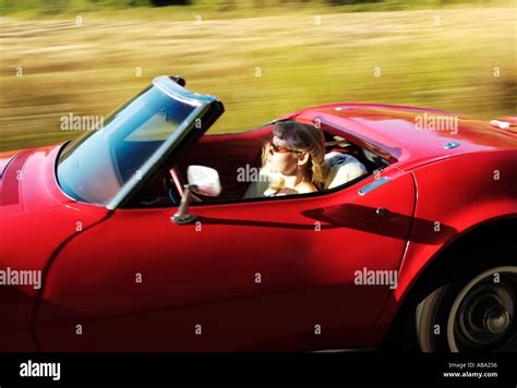 blond girl driving red convertible corvette Stock Photo - Alamy