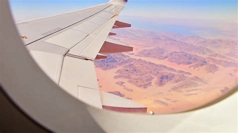 Airplane window view with beautiful textures and landscape of wadi rum ...