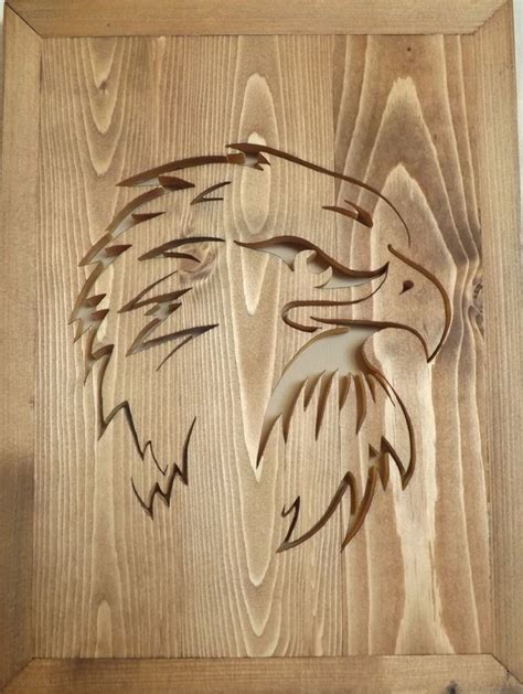 an eagle head carved into wood on a wall