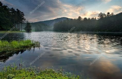 Sunrise over tranquil mountain lake — Stock Photo © mtilghma #11660798