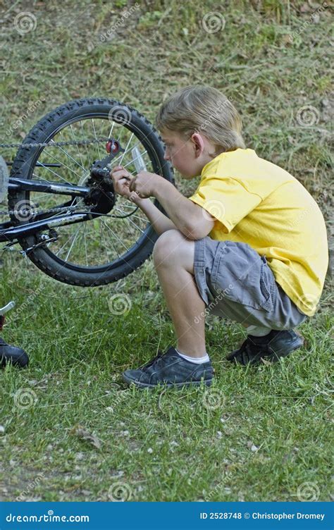 Boy Fixing Bike Gears Royalty Free Stock Photos - Image: 2528748