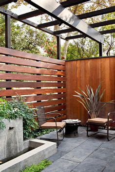 Midcentury patio in Los Angeles with a water feature and a pergola ...