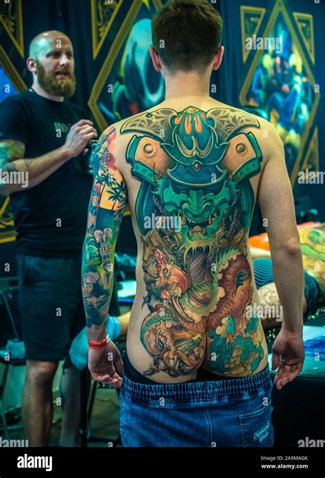 Man with Japanese Yakuza tattoo standing back to camera showing work of ...