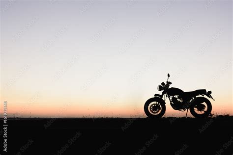 Silhouette of a motorcycle with sunset background Stock Photo | Adobe Stock