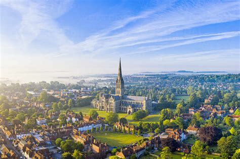 Aerial view over Salisbury and Salisbury Cathedral on a misty summer ...