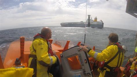 Cargo ship towed to safety after grounding near lighthouse - BBC News