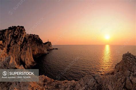 Sunset at cape with lighthouse, Lefkas or Lefkada, Greece, Europe ...