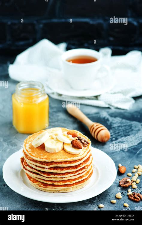 pancakes with dry nuts and honey Stock Photo - Alamy