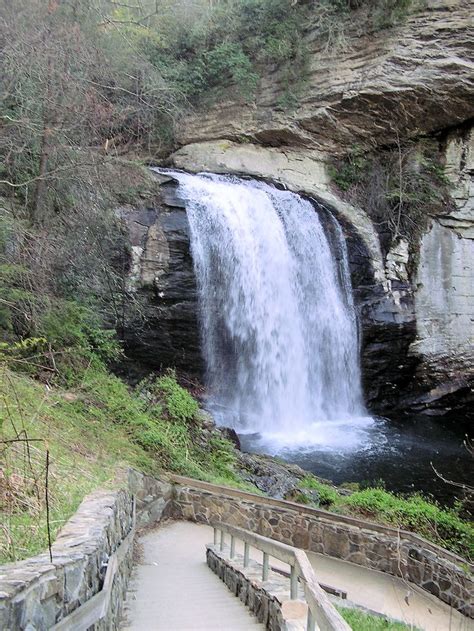 there is a waterfall in the middle of this area with steps leading up to it