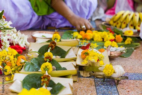 Hindu puja rituals being performed with flowers in front of priest ...