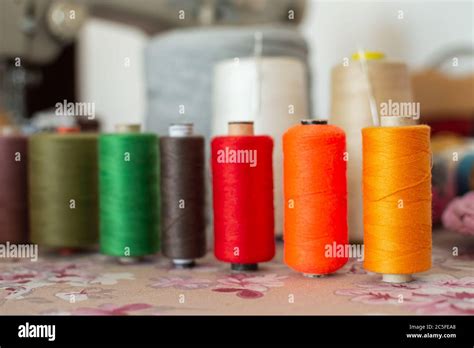 Different colors of threads and sewing machine background Stock Photo ...