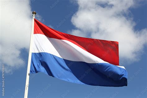 Dutch national flag on liberty day against blue sky with clouds Stock ...