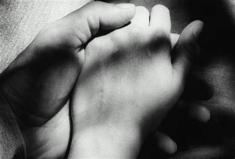 Couple Holding Hands, Close-up Of Hands by Martine Mouchy