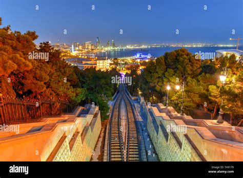 Baku Funicular with a view of the city skyline at night in Azerbaijan ...