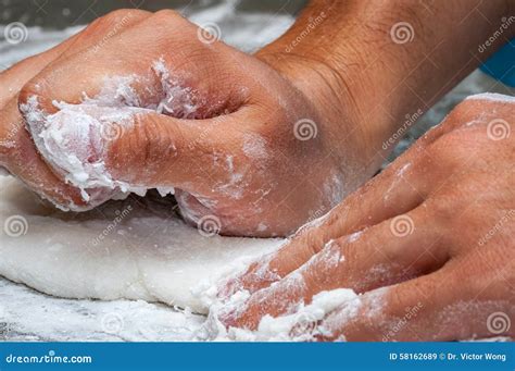 Chef s hand kneading dough stock image. Image of food - 58162689