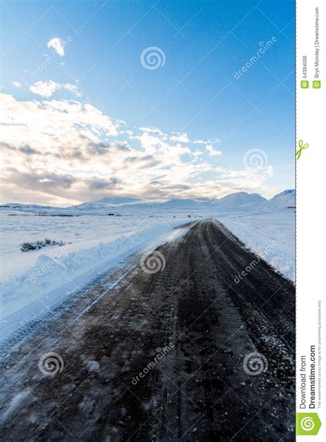 Black Road through Snow stock photo. Image of snow, clouds - 54394006