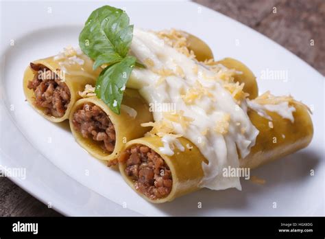 Cannelloni pasta stuffed with meat and bechamel sauce and basil on the ...