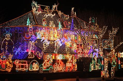 A man stops to admire Christmas festive lights displayed on a detached ...