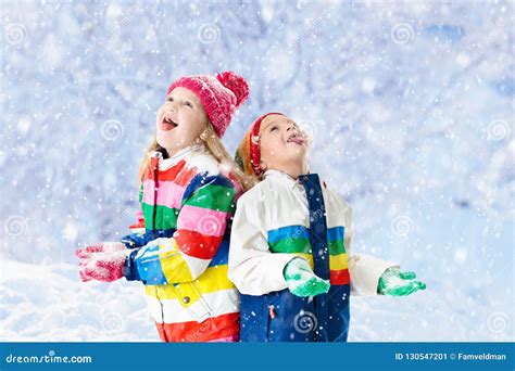 Kids Playing in Snow. Children Play in Winter. Stock Image - Image of ...