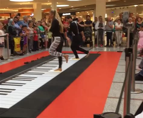 Duo’s Floor Piano Playing Draws Enthusiastic Crowd